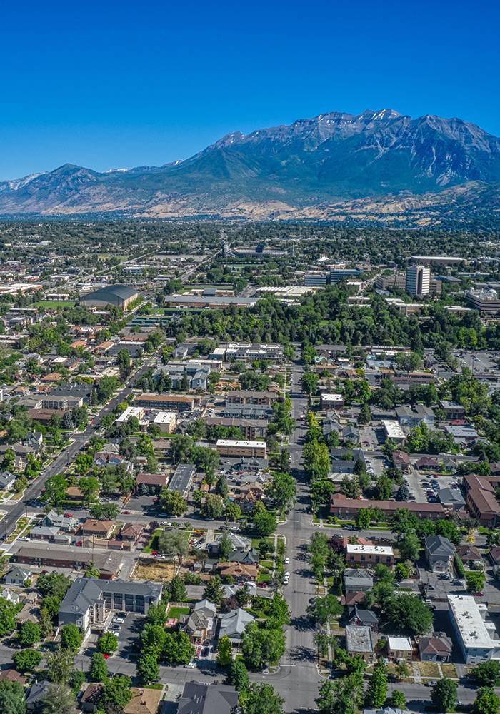 aerial shot of neighborhood with mountains in the distance